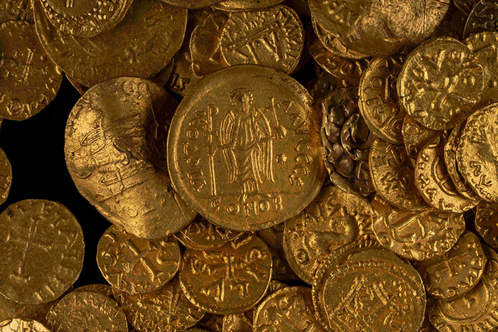 A close up of a pile of gold coins