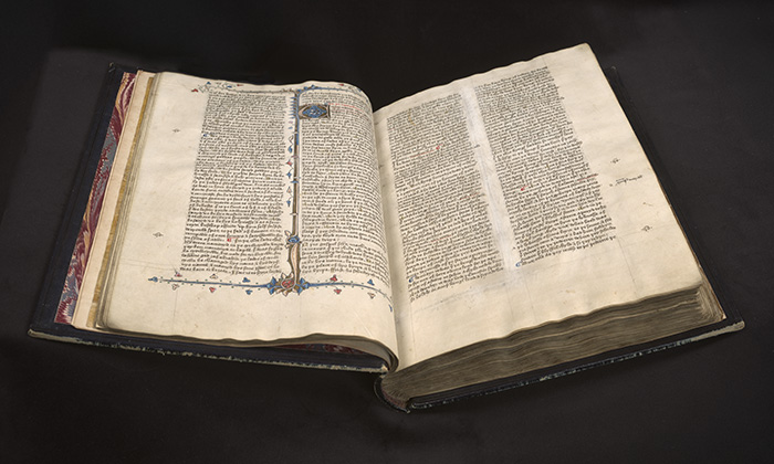 A bound Medieval manuscript open to show text in two columns