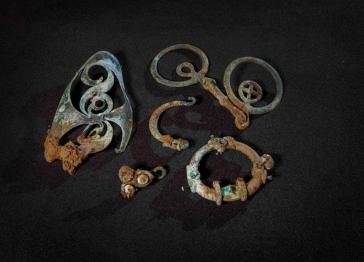 Several intricate metal objects on a black background