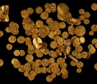 Many gold coins on a black background