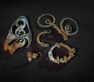 Several intricate metal objects on a black background